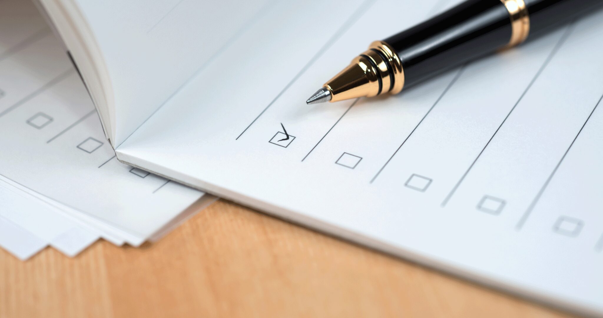 An image of a notes checklist focused on a box with a checkmark and a black ballpen